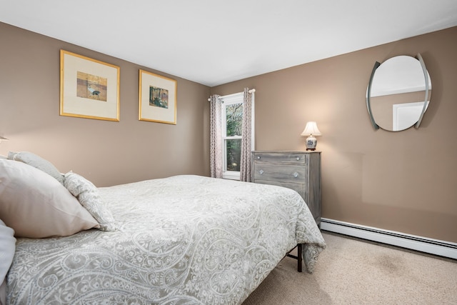 bedroom with carpet and a baseboard heating unit