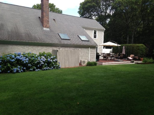 56 Allan Rd, West Barnstable, MA 02668 - rear view of house with a chimney and a lawn