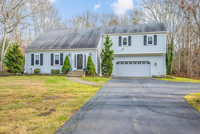 view of front of property with a garage and a front yard