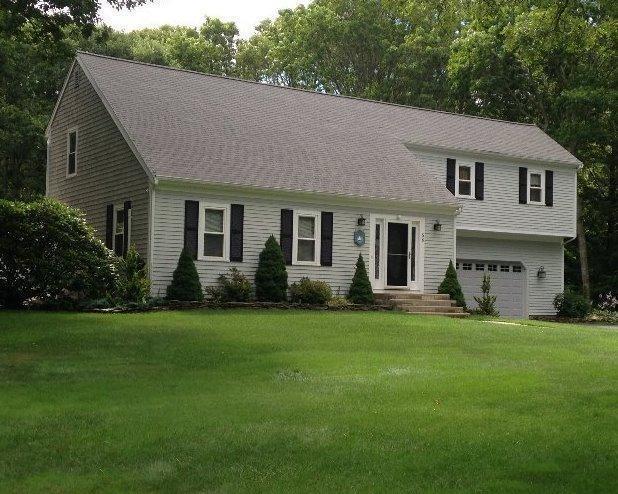 56 Allan Rd, West Barnstable, MA 02668 - view of front of home with a front yard and a garage