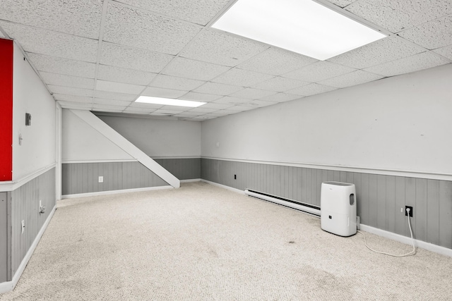 56 Allan Rd, West Barnstable, MA 02668 - finished basement with a baseboard heating unit, a paneled ceiling, carpet flooring, and wainscoting
