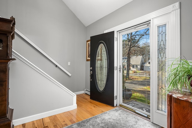 56 Allan Rd, West Barnstable, MA 02668 - entryway with stairs, a baseboard radiator, vaulted ceiling, wood finished floors, and baseboards