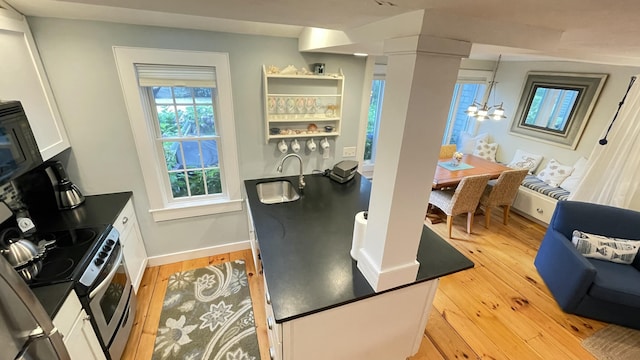 40 Brant Rock Rd, Mashpee, MA 02649 - dining room with light wood-style flooring, a chandelier, and bar with sink