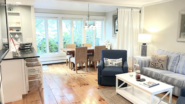40 Brant Rock Rd, Mashpee, MA 02649 - living room featuring a baseboard heating unit, light wood finished floors, and a chandelier