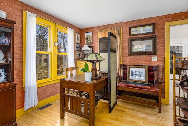 office area featuring wood-type flooring, visible vents, and baseboards