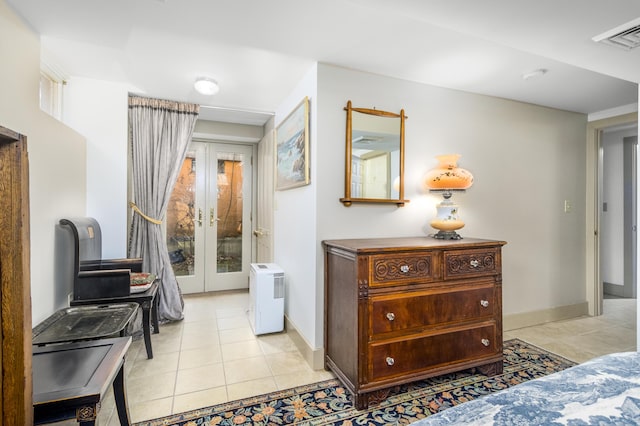 corridor with french doors, visible vents, baseboards, and light tile patterned floors