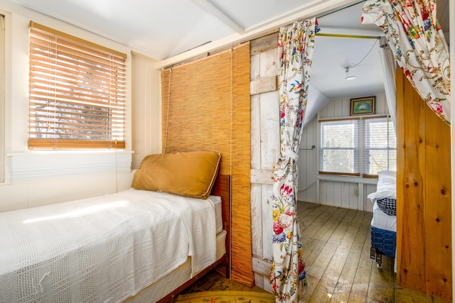 bedroom with lofted ceiling and hardwood / wood-style flooring