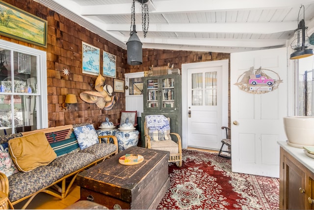 living area with vaulted ceiling with beams, wooden ceiling, and wooden walls