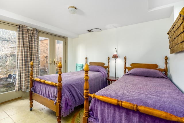 tiled bedroom featuring access to outside and french doors