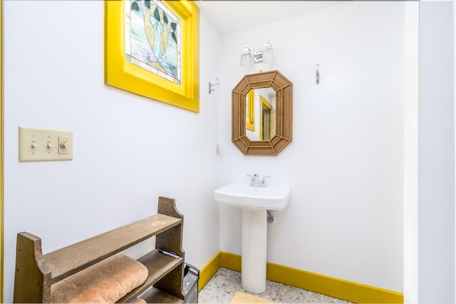 bathroom with baseboards and a sink