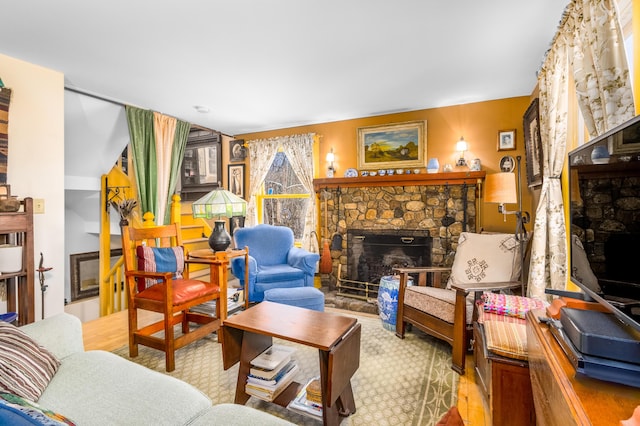 living area featuring a stone fireplace