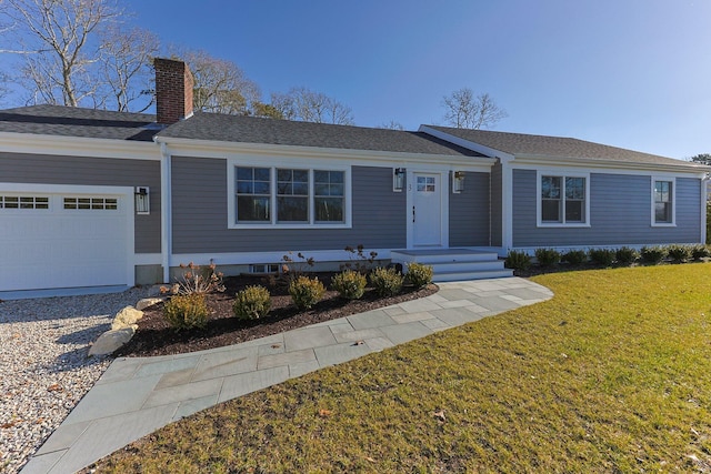 ranch-style house featuring a front yard and a garage