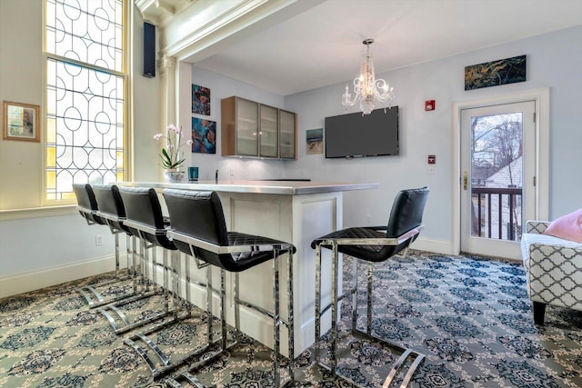 143 Main St, Sandwich, MA 02563 - bar with a community bar, baseboards, an inviting chandelier, carpet, and hanging light fixtures