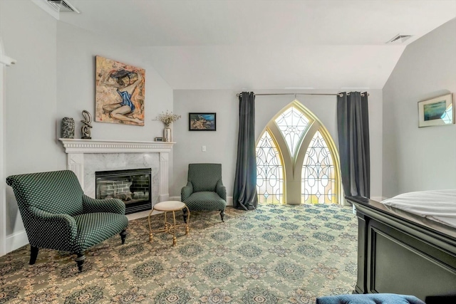 143 Main St, Sandwich, MA 02563 - sitting room with a fireplace, visible vents, vaulted ceiling, and carpet floors