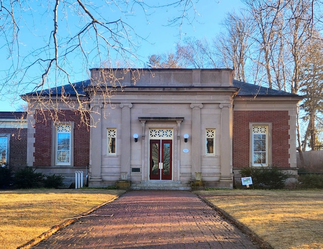 143 Main St, Sandwich, MA 02563 - view of front facade featuring a front lawn and brick siding