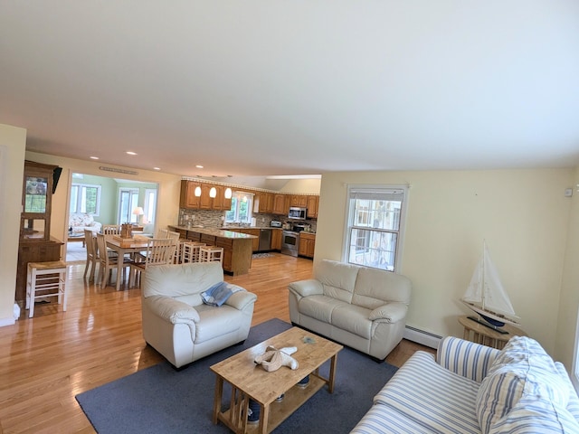 32 Apple Ln, Dennis, MA 02638 - living room featuring baseboard heating, light wood-type flooring, and recessed lighting