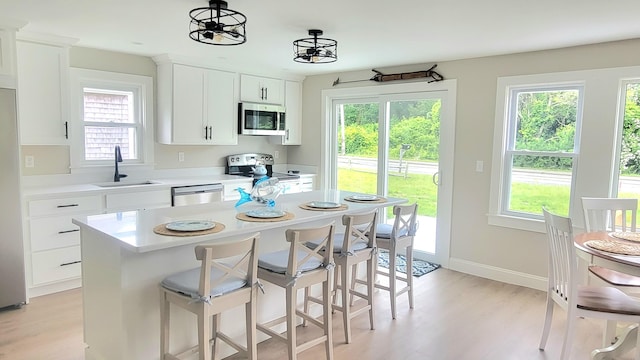2-A Bodfish Ave, Sandwich, MA 02563 - kitchen with appliances with stainless steel finishes, plenty of natural light, light countertops, and light wood-style floors