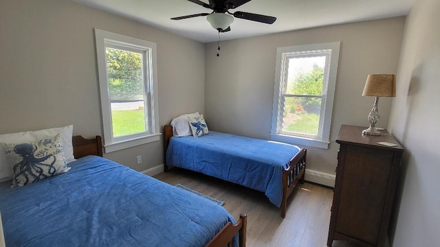 2-A Bodfish Ave, Sandwich, MA 02563 - bedroom with multiple windows, a baseboard radiator, and light wood-style flooring