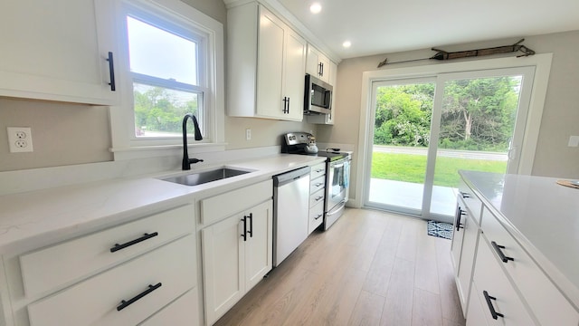 2-A Bodfish Ave, Sandwich, MA 02563 - kitchen with appliances with stainless steel finishes, light wood finished floors, white cabinets, recessed lighting, and light stone countertops