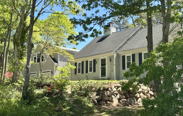 91 Hitching Post Ln, Centerville, MA 02632 - rear view of house featuring a shingled roof and a chimney