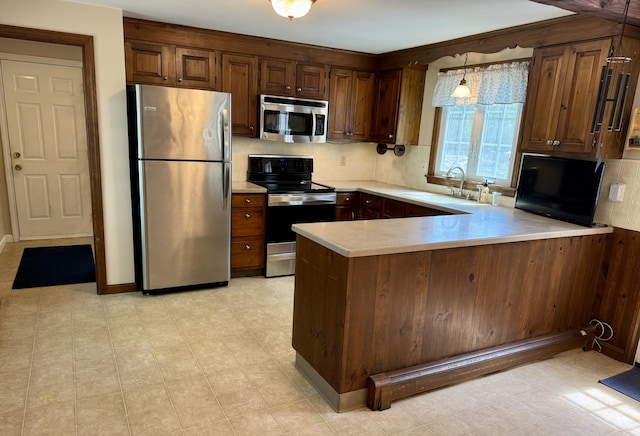 91 Hitching Post Ln, Centerville, MA 02632 - kitchen featuring appliances with stainless steel finishes, a sink, light countertops, and tasteful backsplash