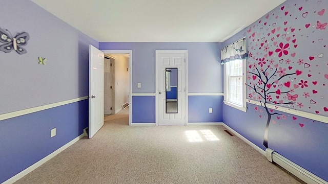 91 Hitching Post Ln, Centerville, MA 02632 - unfurnished bedroom featuring a baseboard heating unit, carpet flooring, and baseboards