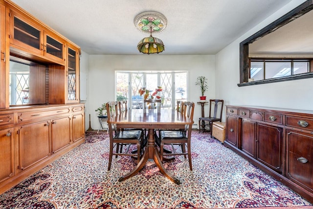 dining area featuring a textured ceiling