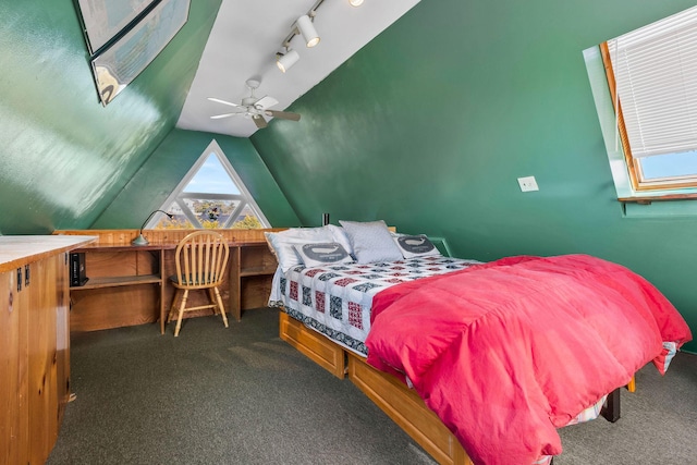 bedroom featuring ceiling fan, dark carpet, and lofted ceiling