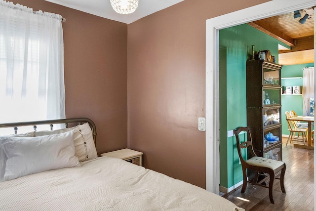 bedroom featuring dark hardwood / wood-style floors and a chandelier