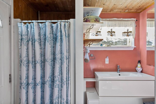 bathroom with wood ceiling and sink