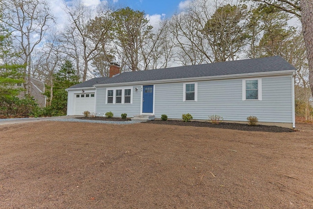 ranch-style home featuring a garage, driveway, a chimney, and entry steps