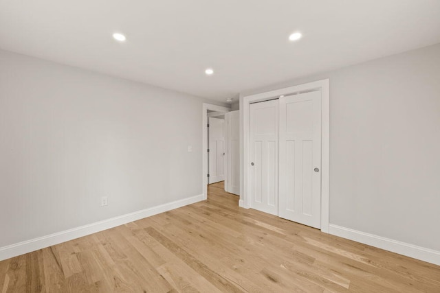 unfurnished bedroom featuring recessed lighting, baseboards, and light wood-style floors