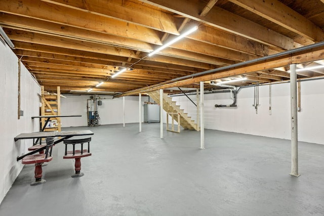unfinished below grade area with stairs and water heater