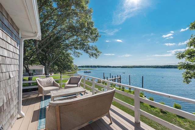 wooden terrace with a water view and a boat dock