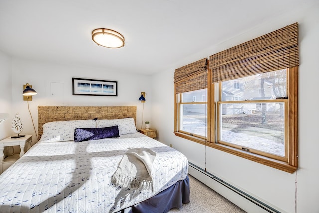 carpeted bedroom with baseboard heating