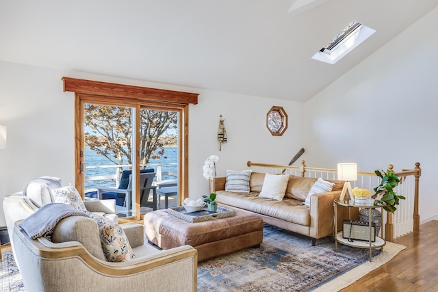 living room with lofted ceiling with skylight and wood finished floors