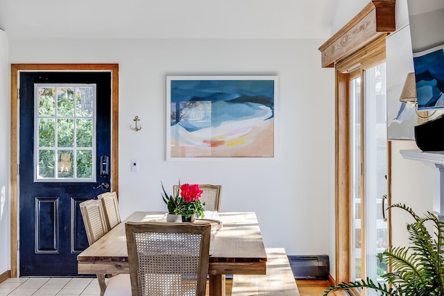 dining area featuring light tile patterned floors and a baseboard radiator