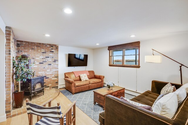 30 Overland Rd, Mashpee, MA 02649 - living room with wood finished floors, a wood stove, a baseboard radiator, recessed lighting, and a baseboard heating unit