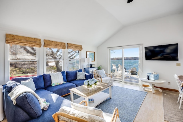 living room with lofted ceiling, baseboards, and wood finished floors