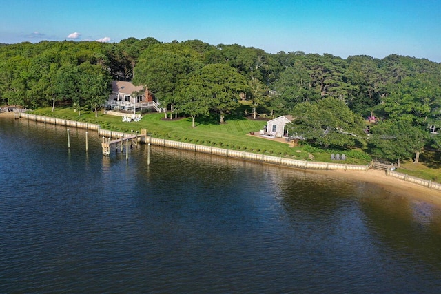 bird's eye view with a water view and a wooded view