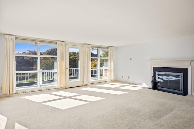 unfurnished living room featuring carpet floors and a fireplace with flush hearth