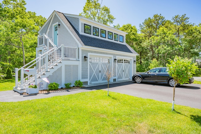 79 Neshobe Rd, Mashpee, MA 02649 - view of front of property with a shingled roof, a front yard, driveway, and an attached garage