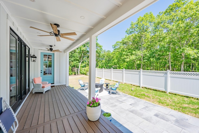 79 Neshobe Rd, Mashpee, MA 02649 - wooden terrace with a fenced backyard, a ceiling fan, a patio, and view of wooded area