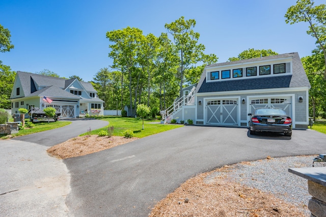 79 Neshobe Rd, Mashpee, MA 02649 - view of front of home with asphalt driveway, a front lawn, a garage, stairway, and a shingled roof