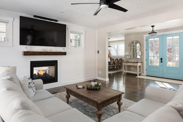 79 Neshobe Rd, Mashpee, MA 02649 - living area with wood finished floors, a multi sided fireplace, ceiling fan, and french doors