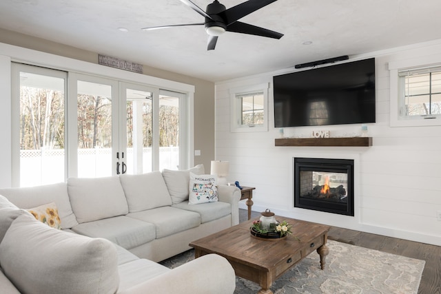 79 Neshobe Rd, Mashpee, MA 02649 - living area with healthy amount of natural light, a ceiling fan, wood finished floors, and a multi sided fireplace