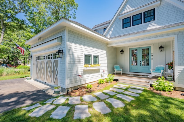 79 Neshobe Rd, Mashpee, MA 02649 - view of front of house with french doors, an attached garage, and covered porch
