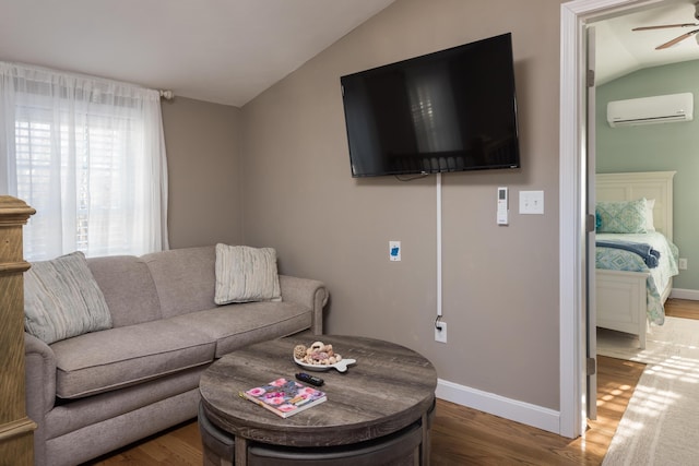 79 Neshobe Rd, Mashpee, MA 02649 - living room with a wall mounted AC, vaulted ceiling, a ceiling fan, and wood finished floors