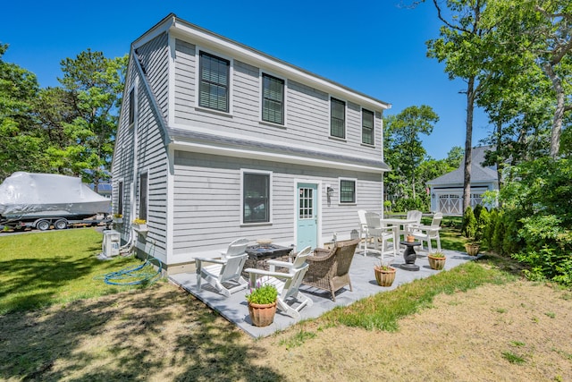 79 Neshobe Rd, Mashpee, MA 02649 - rear view of house featuring a yard and a patio