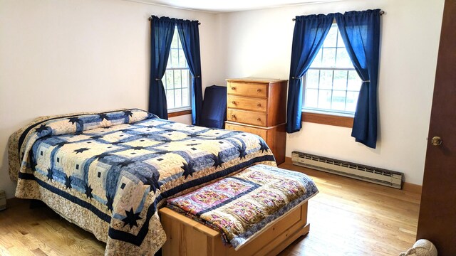 13 Pilgrim Ln, Eastham, MA 02642 - bedroom with a baseboard heating unit, multiple windows, and wood finished floors